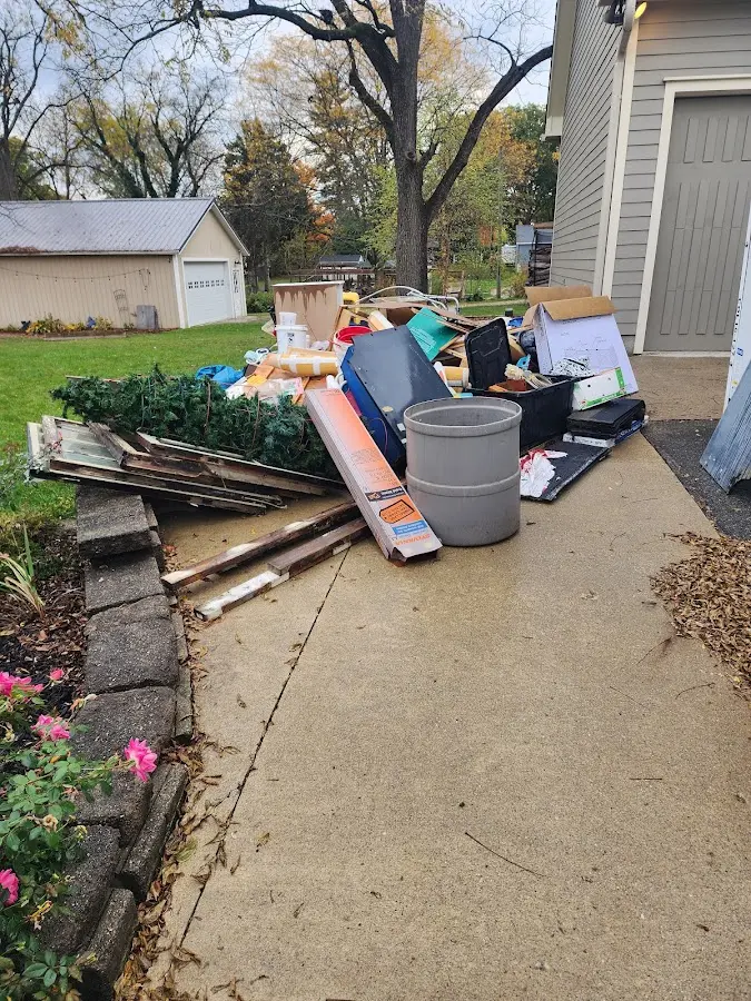 Dumpster being loaded with debris for Estate Cleanout Dumpster Rental in Holland
